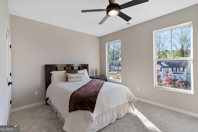 6960 Dockbridge Way, Stone Mountain, GA 30087 - carpeted bedroom with multiple windows and a ceiling fan