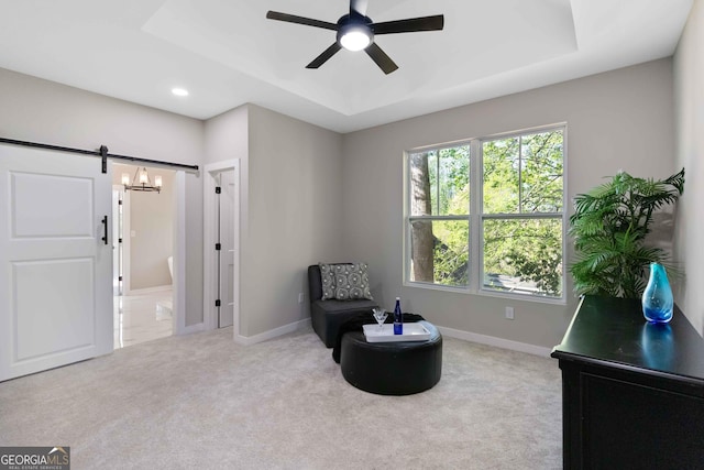 6960 Dockbridge Way, Stone Mountain, GA 30087 - living area featuring a tray ceiling, ceiling fan, carpet flooring, a barn door, and recessed lighting