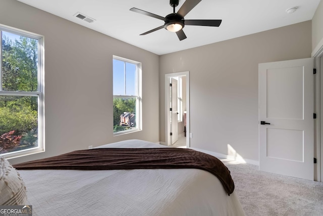 6960 Dockbridge Way, Stone Mountain, GA 30087 - carpeted bedroom featuring a ceiling fan and ensuite bath