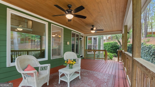 wooden deck featuring ceiling fan