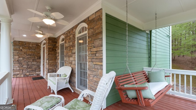 wooden deck featuring a porch and a ceiling fan