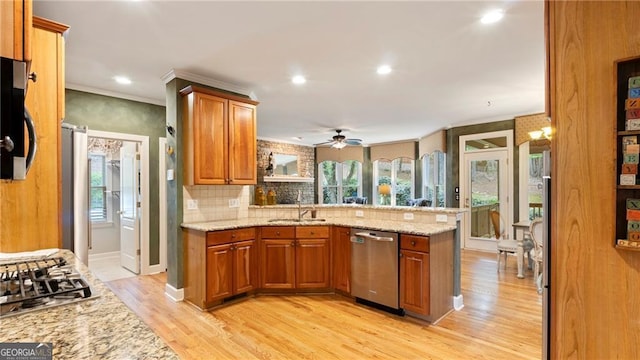 104 Kremer Falls Trce, Canton, GA 30114 - kitchen featuring stainless steel appliances, a peninsula, brown cabinetry, a ceiling fan, and light wood-type flooring