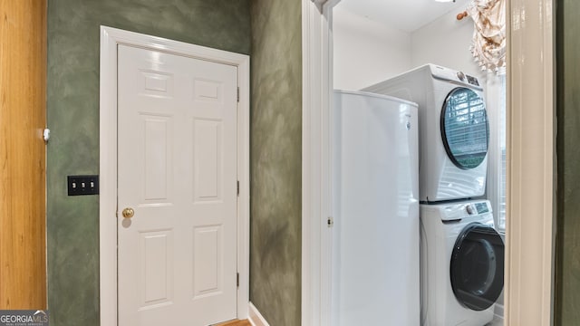 laundry room featuring stacked washing maching and dryer and laundry area