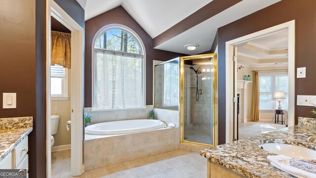 bathroom featuring a garden tub, vanity, tile patterned flooring, toilet, and a stall shower
