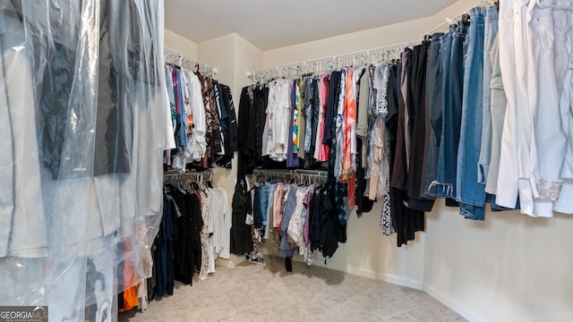 walk in closet with carpet floors