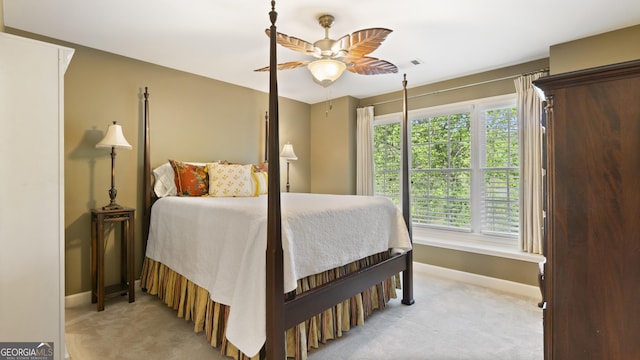 bedroom featuring baseboards, multiple windows, and light carpet