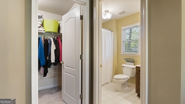 bathroom featuring visible vents, toilet, vanity, and tile patterned flooring