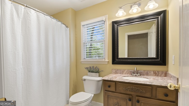 bathroom featuring toilet and vanity