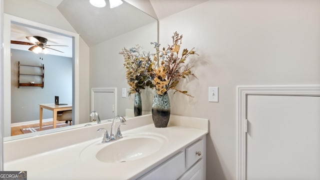 bathroom featuring ceiling fan, vanity, and vaulted ceiling