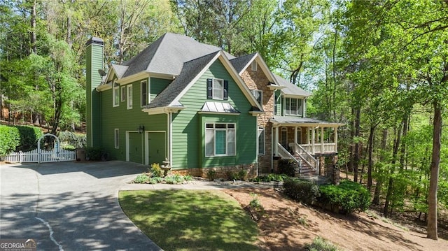 104 Kremer Falls Trce, Canton, GA 30114 - view of front of home with driveway, a chimney, stairway, covered porch, and a gate