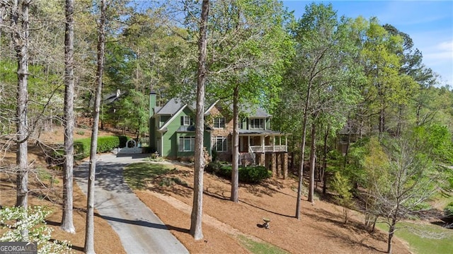 104 Kremer Falls Trce, Canton, GA 30114 - view of front of home with asphalt driveway, covered porch, stairway, and view of wooded area
