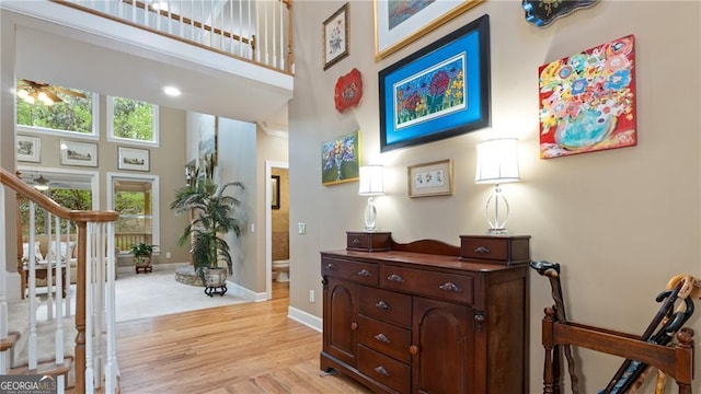 104 Kremer Falls Trce, Canton, GA 30114 - foyer entrance with stairs, a high ceiling, light wood finished floors, and baseboards