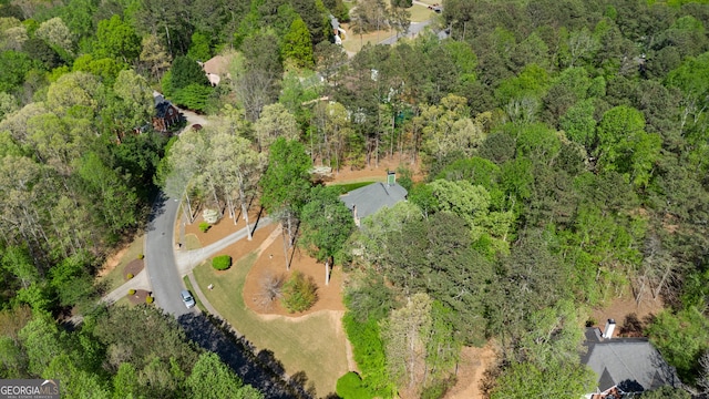 aerial view featuring a wooded view