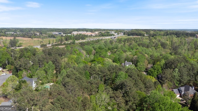 birds eye view of property with a view of trees