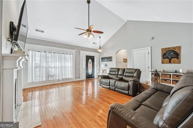 698 Jefferson Hwy, Winder, GA 30680 - living room with a ceiling fan, arched walkways, wood finished floors, high vaulted ceiling, and a high end fireplace