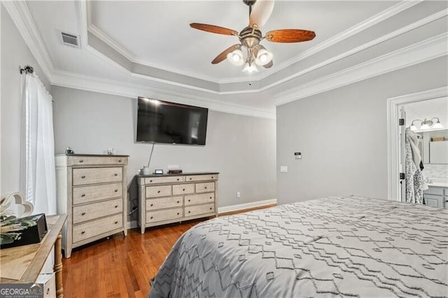 698 Jefferson Hwy, Winder, GA 30680 - bedroom featuring wood finished floors, a raised ceiling, ornamental molding, a ceiling fan, and ensuite bathroom