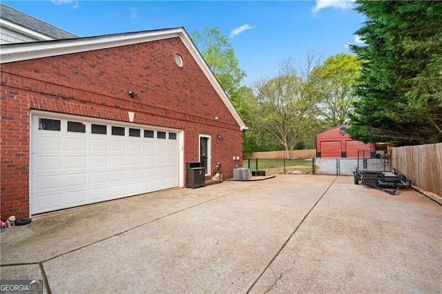 698 Jefferson Hwy, Winder, GA 30680 - view of property exterior with brick siding, driveway, a garage, and an outdoor structure