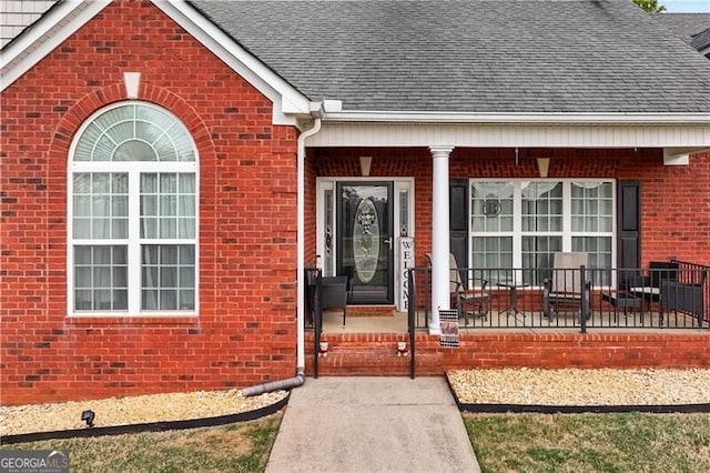 698 Jefferson Hwy, Winder, GA 30680 - view of exterior entry featuring a shingled roof, brick siding, and a porch