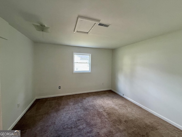 carpeted empty room featuring visible vents and baseboards