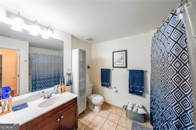 bathroom with visible vents, toilet, tile patterned flooring, and vanity