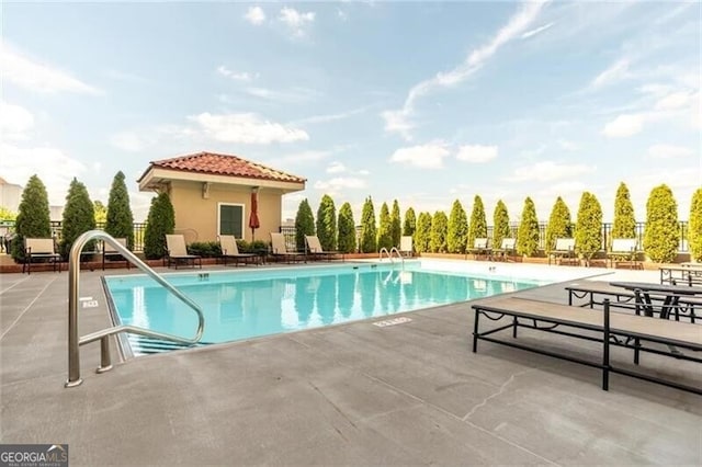 pool featuring a patio and fence