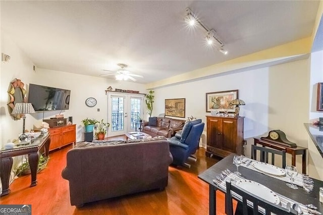 living room featuring french doors, wood finished floors, and ceiling fan