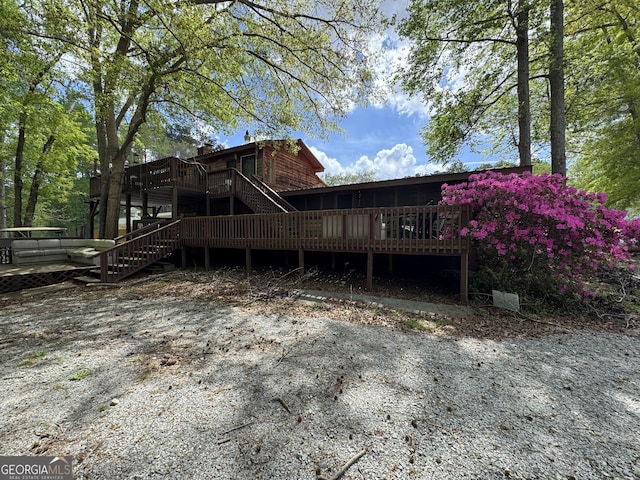 rear view of property with a deck and stairs