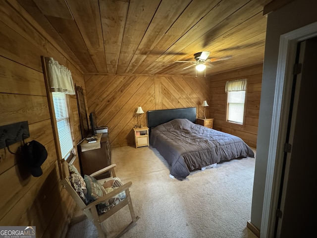 bedroom featuring wood walls, carpet, and wood ceiling