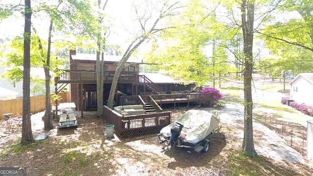 exterior space featuring stairs, a deck, and fence