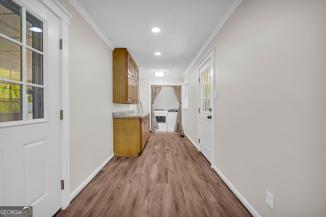 hall featuring recessed lighting, baseboards, ornamental molding, and wood finished floors