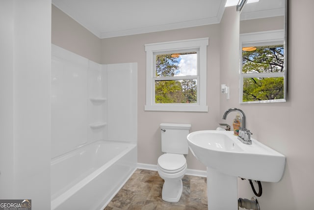 bathroom with crown molding, tub / shower combination, stone finish floor, toilet, and baseboards