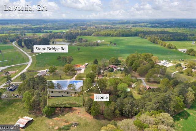 birds eye view of property featuring a rural view