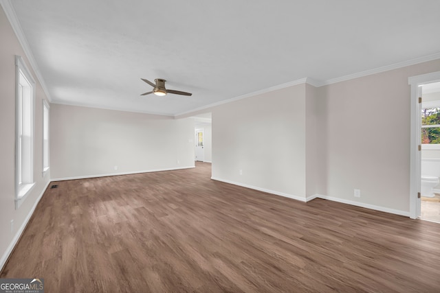unfurnished living room featuring baseboards, wood finished floors, crown molding, and ceiling fan