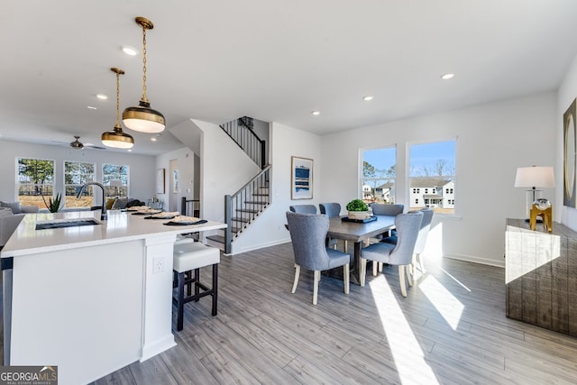 dining room featuring light wood-style flooring, recessed lighting, a ceiling fan, and stairway