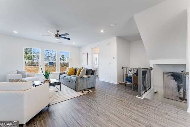 living area with recessed lighting, a ceiling fan, wood finished floors, and baseboards