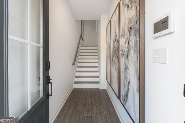 interior space with baseboards, stairs, and dark wood-style floors