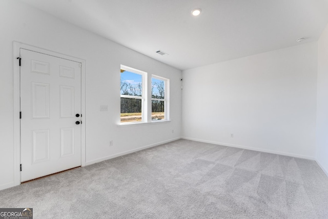 carpeted empty room with baseboards and visible vents