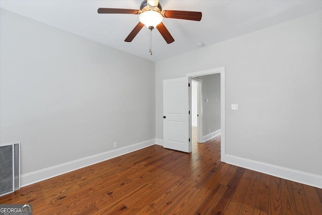 empty room with visible vents, baseboards, a ceiling fan, and hardwood / wood-style flooring