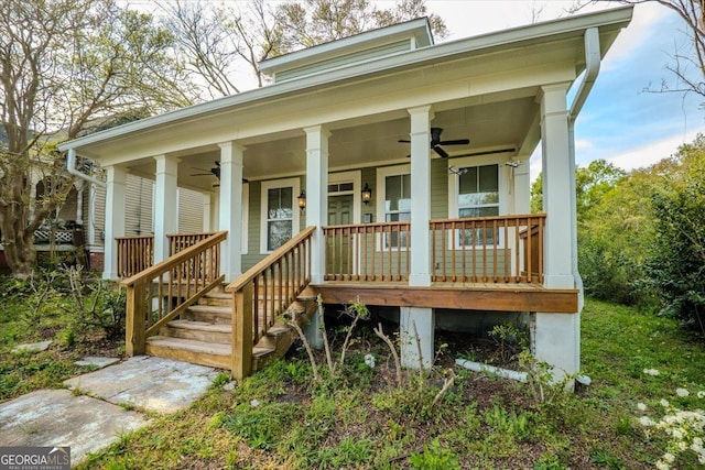 doorway to property featuring covered porch and a ceiling fan