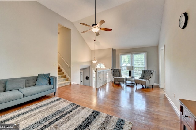 6040 Carriage Dr, Cumming, GA 30028 - living room featuring ceiling fan, high vaulted ceiling, and wood finished floors