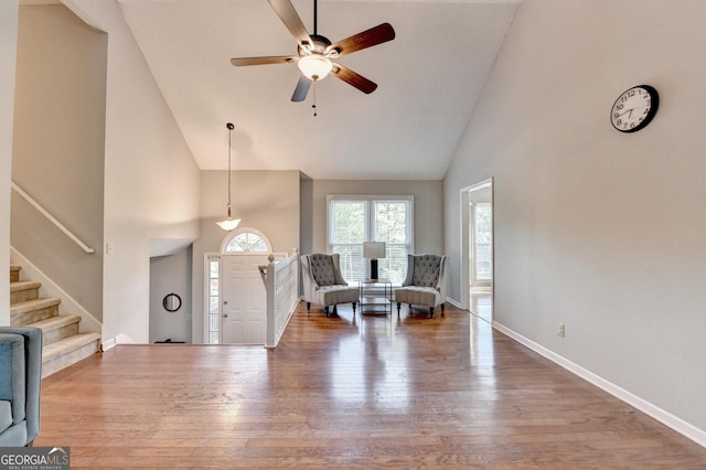6040 Carriage Dr, Cumming, GA 30028 - entrance foyer with baseboards, a ceiling fan, wood finished floors, stairs, and high vaulted ceiling