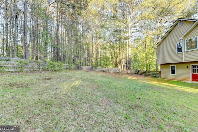 6040 Carriage Dr, Cumming, GA 30028 - view of yard featuring a wooded view and a fenced backyard