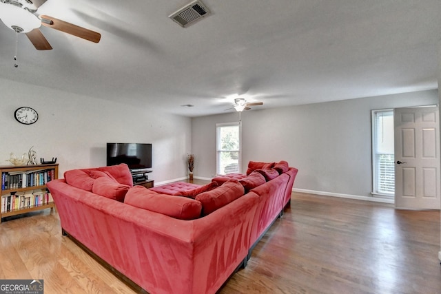 6040 Carriage Dr, Cumming, GA 30028 - living room with baseboards, visible vents, light wood-type flooring, and a ceiling fan