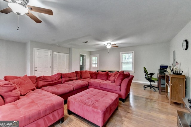 6040 Carriage Dr, Cumming, GA 30028 - living room with light wood-style flooring, baseboards, visible vents, and ceiling fan