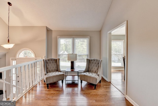 6040 Carriage Dr, Cumming, GA 30028 - sitting room with wood finished floors, baseboards, vaulted ceiling, and a wealth of natural light