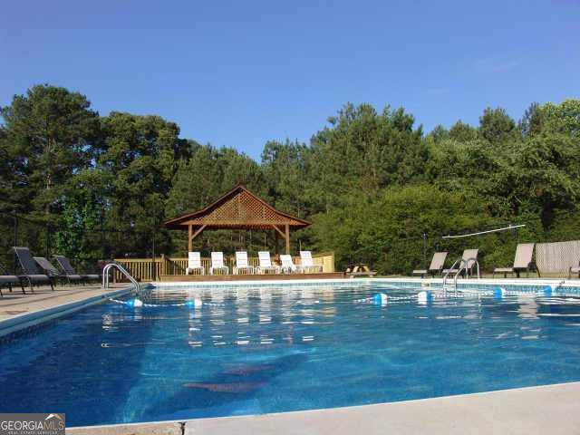 6040 Carriage Dr, Cumming, GA 30028 - community pool featuring a patio, a gazebo, and fence