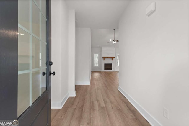 hallway featuring baseboards and wood finished floors