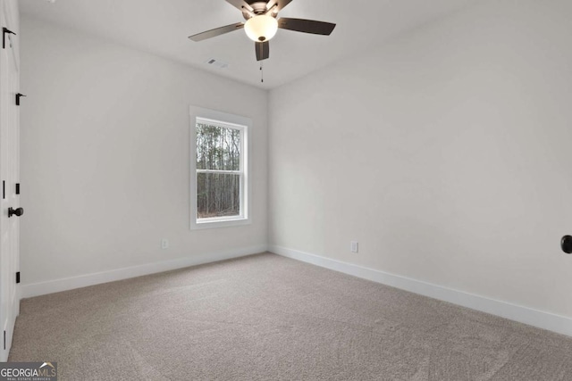 unfurnished room featuring visible vents, baseboards, ceiling fan, and carpet