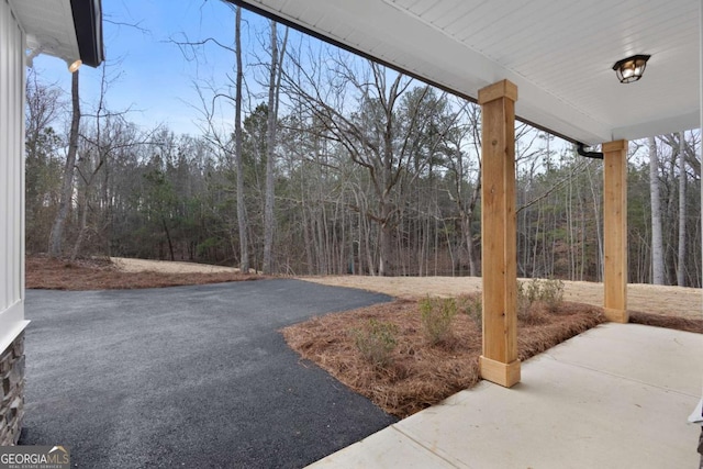 view of patio with a view of trees