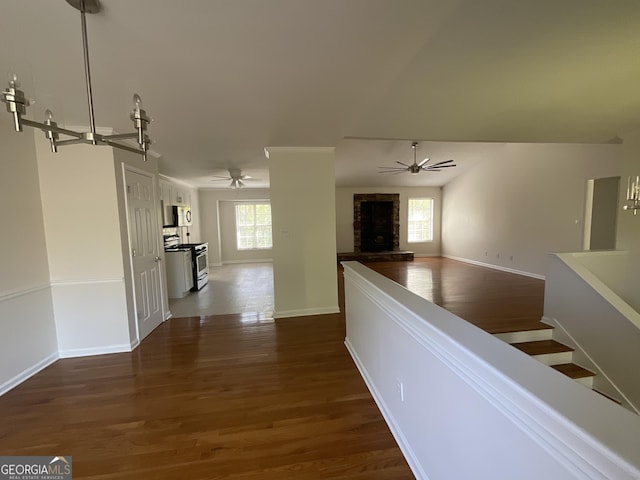 hallway featuring baseboards and dark wood-style flooring